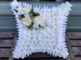 white ribbon edge cushion